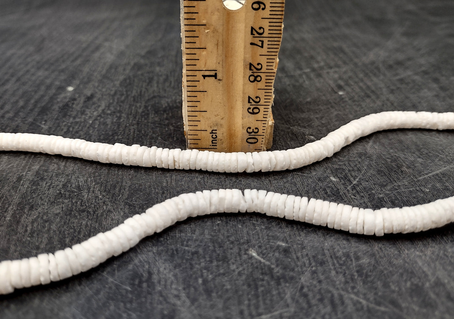 White Puka-Style Shell Necklace - (1 necklace 18 inches x 4-5mm) on blue background. Copyright 2022 SeaShellSupply.com.