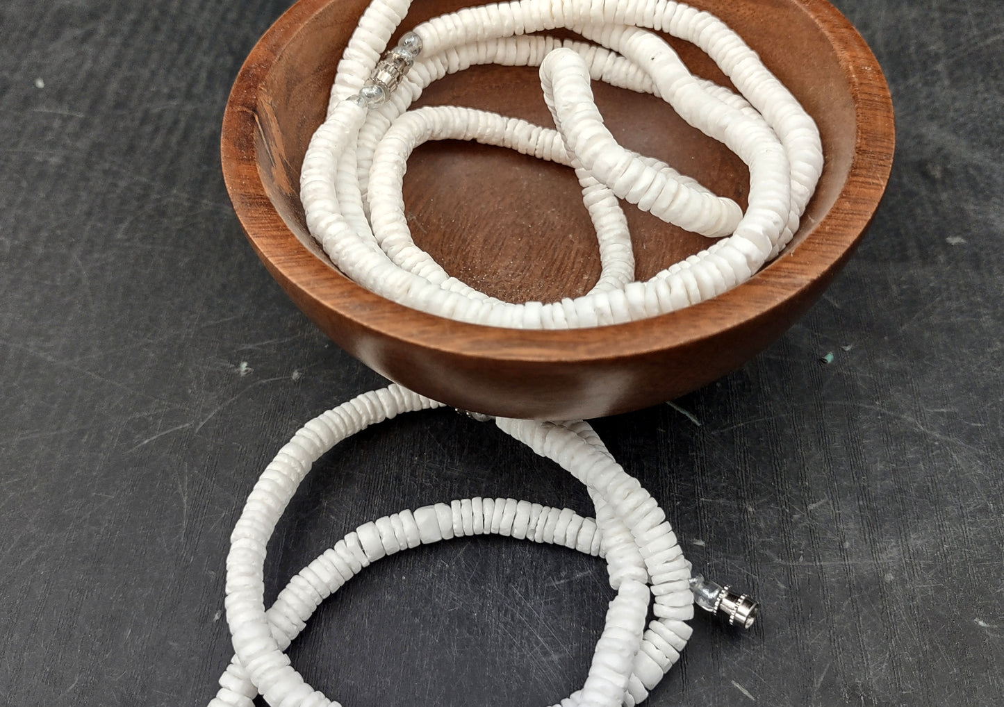 White Puka-Style Shell Necklace - (1 necklace 18 inches x 4-5mm) on blue background. Copyright 2022 SeaShellSupply.com.