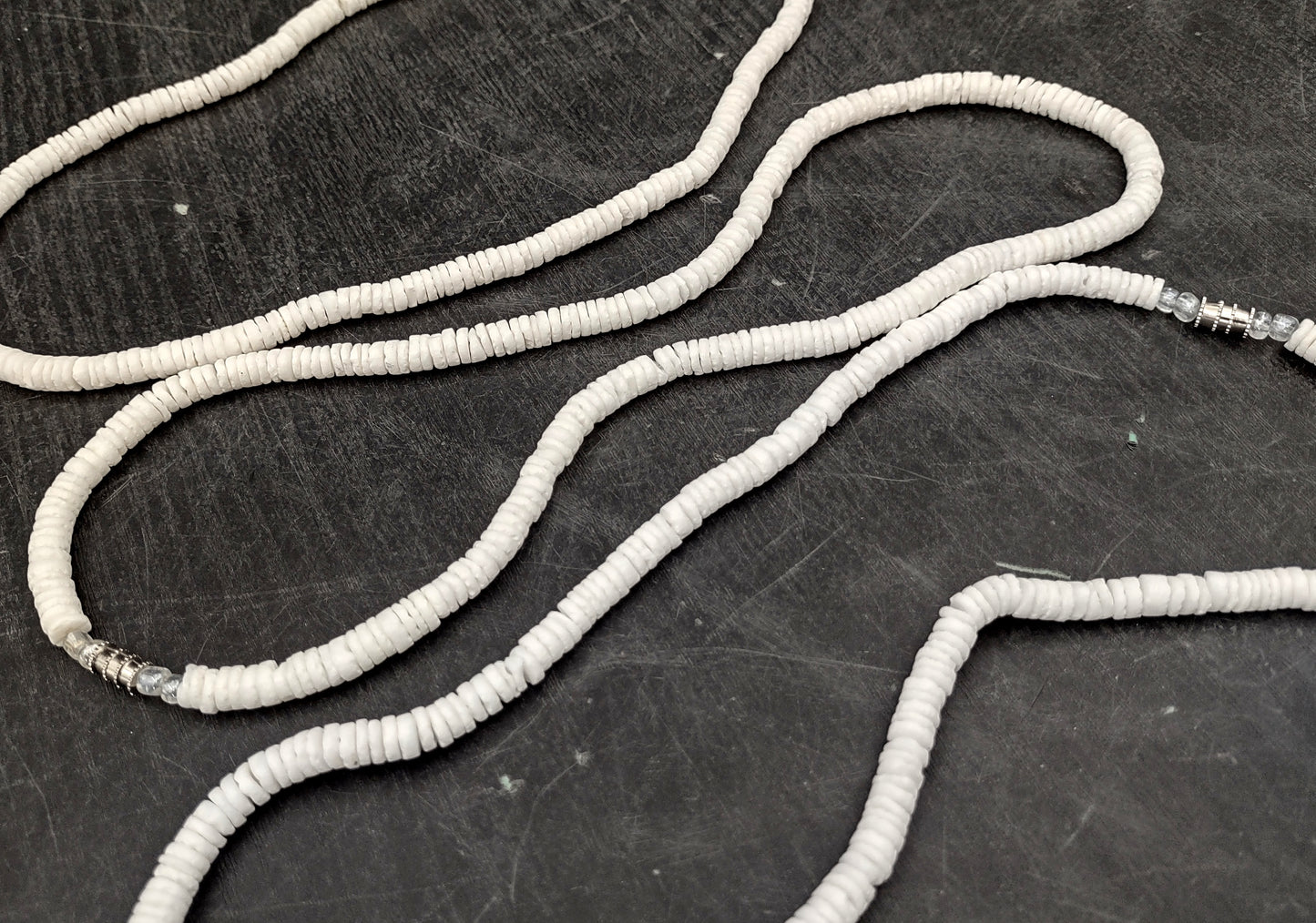 White Puka-Style Shell Necklace - (1 necklace 18 inches x 4-5mm) on blue background. Copyright 2022 SeaShellSupply.com.