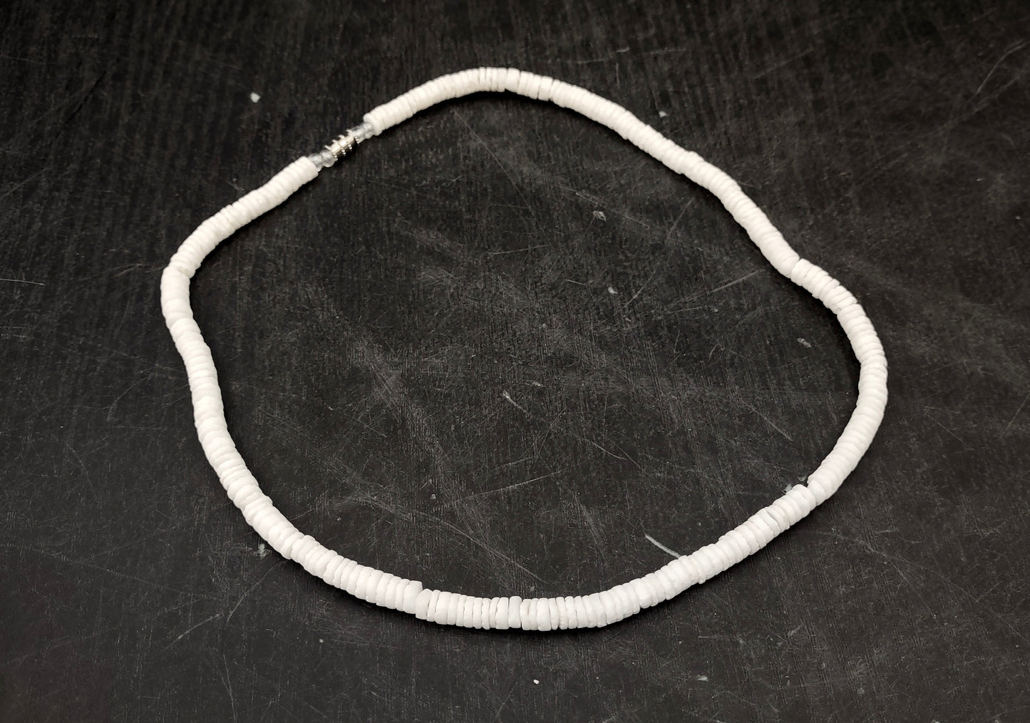 White Puka-Style Shell Necklace - (1 necklace 18 inches x 4-5mm) on blue background. Copyright 2022 SeaShellSupply.com.