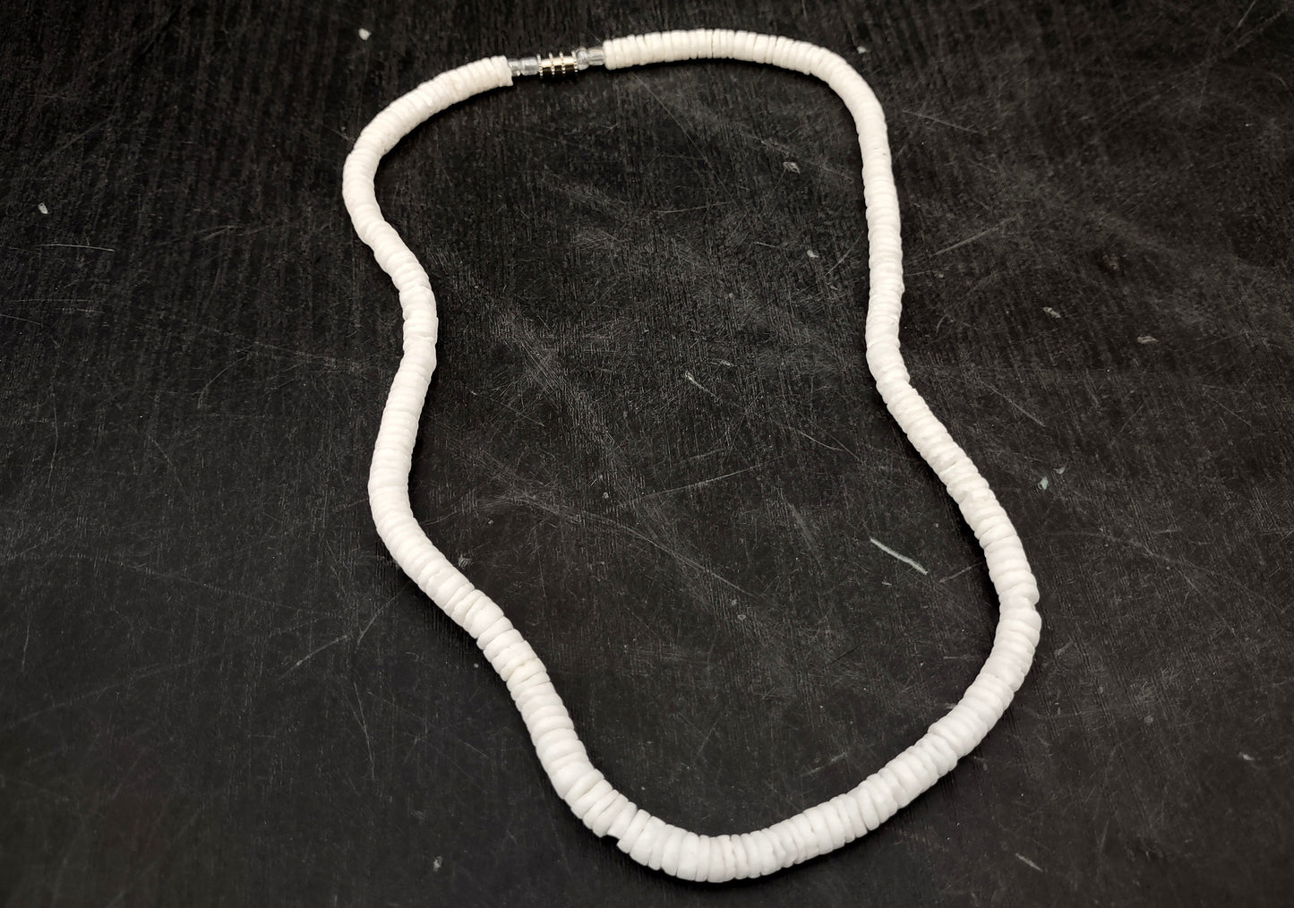 White Puka-Style Shell Necklace - (1 necklace 18 inches x 4-5mm) on blue background. Copyright 2022 SeaShellSupply.com.