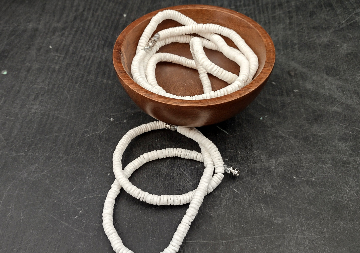 White Puka-Style Shell Necklace - (1 necklace 18 inches x 4-5mm) on blue background. Copyright 2022 SeaShellSupply.com.