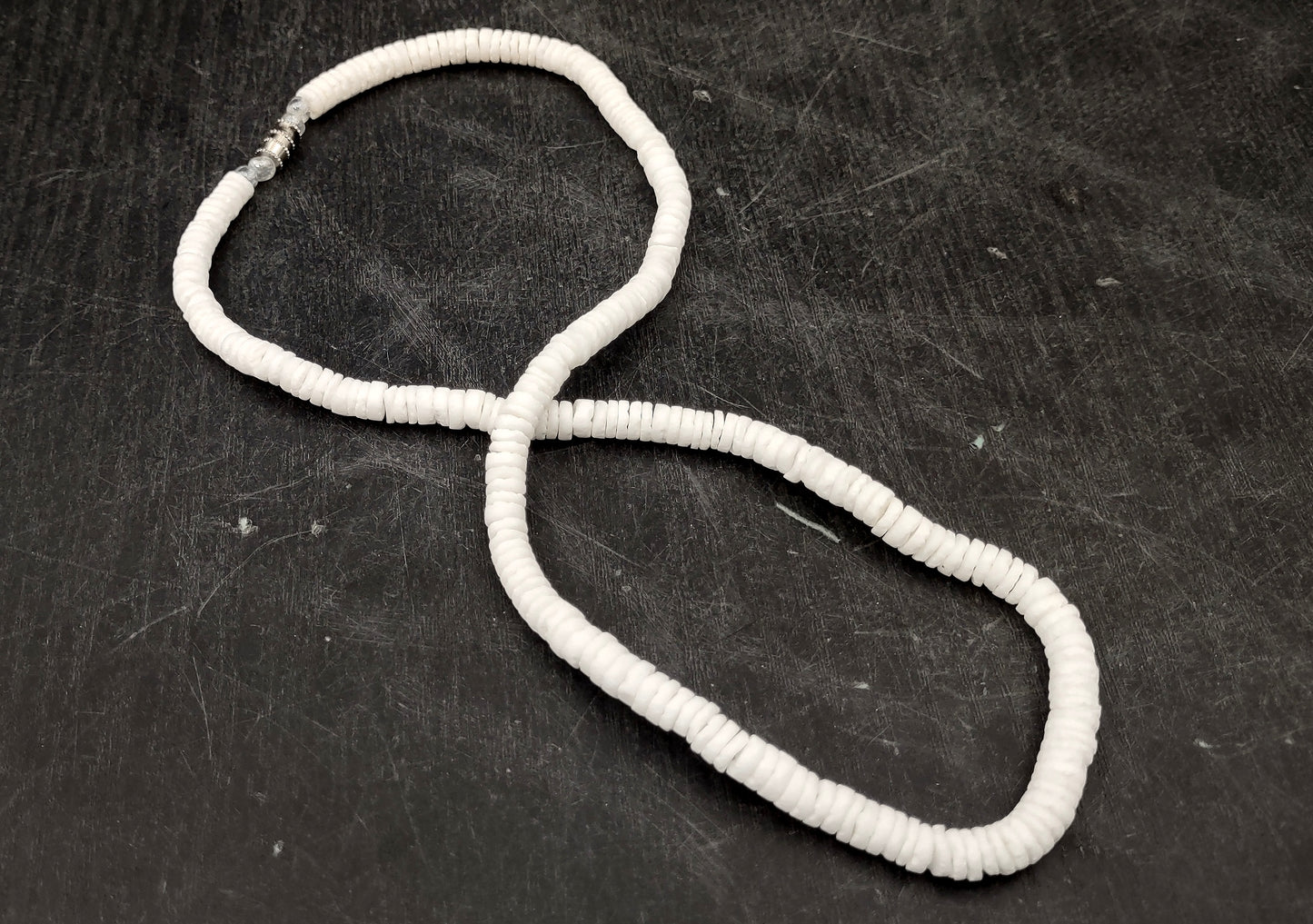 White Puka-Style Shell Necklace - (1 necklace 18 inches x 4-5mm) on blue background. Copyright 2022 SeaShellSupply.com.