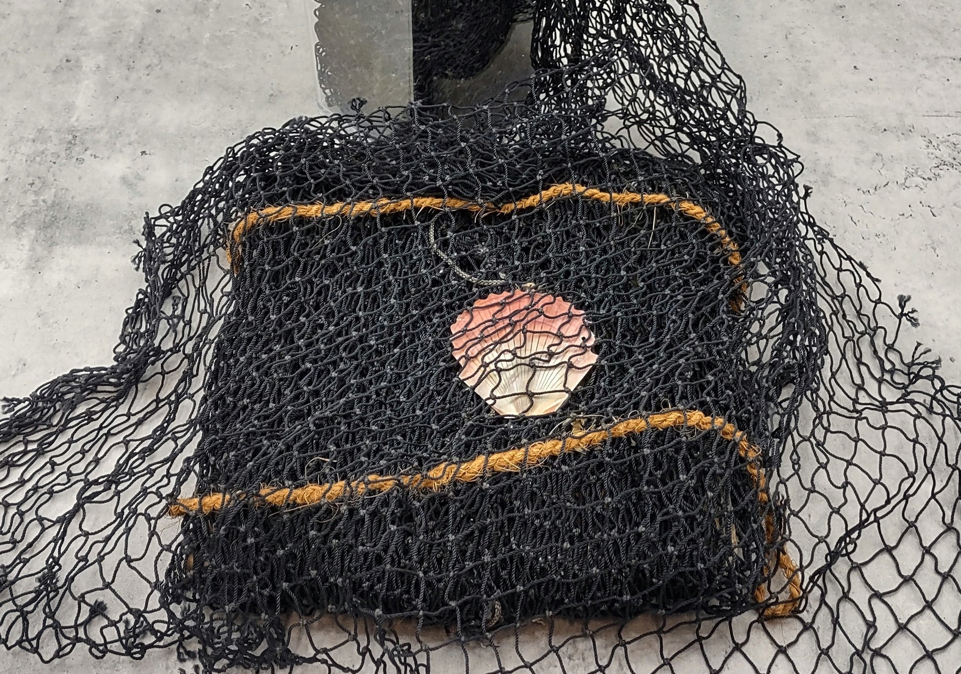 Fishing Net - Used (4 X 9 feet). One black tied fishing net that comes folded and banded. Copyright 2022 SeaShellSupply.com.