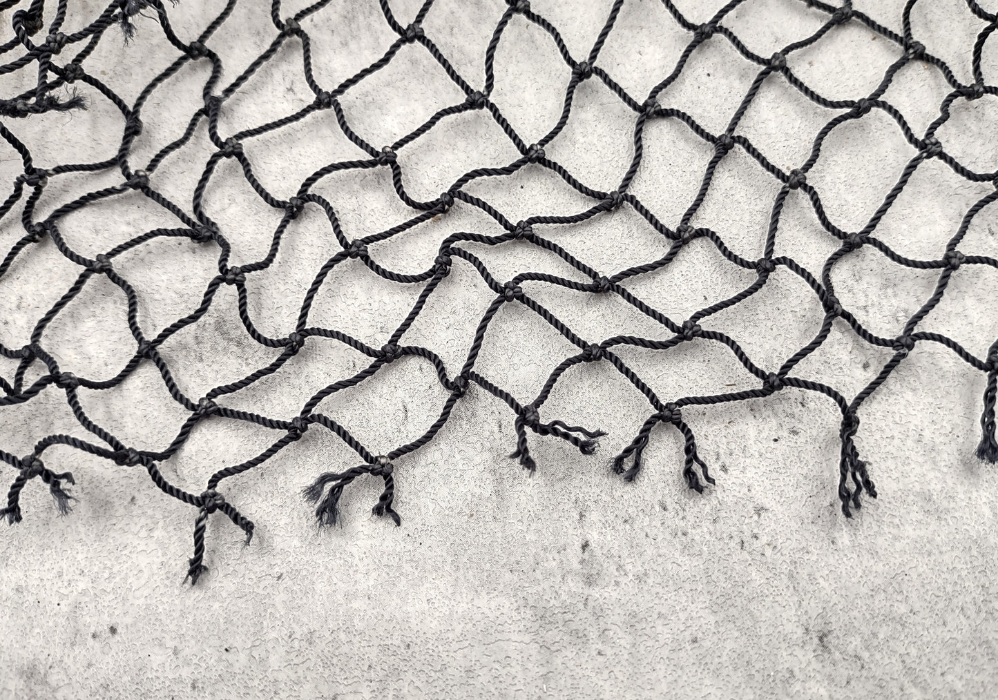 Fishing Net - Used (4 X 9 feet). One black tied fishing net that comes folded and banded. Copyright 2022 SeaShellSupply.com.