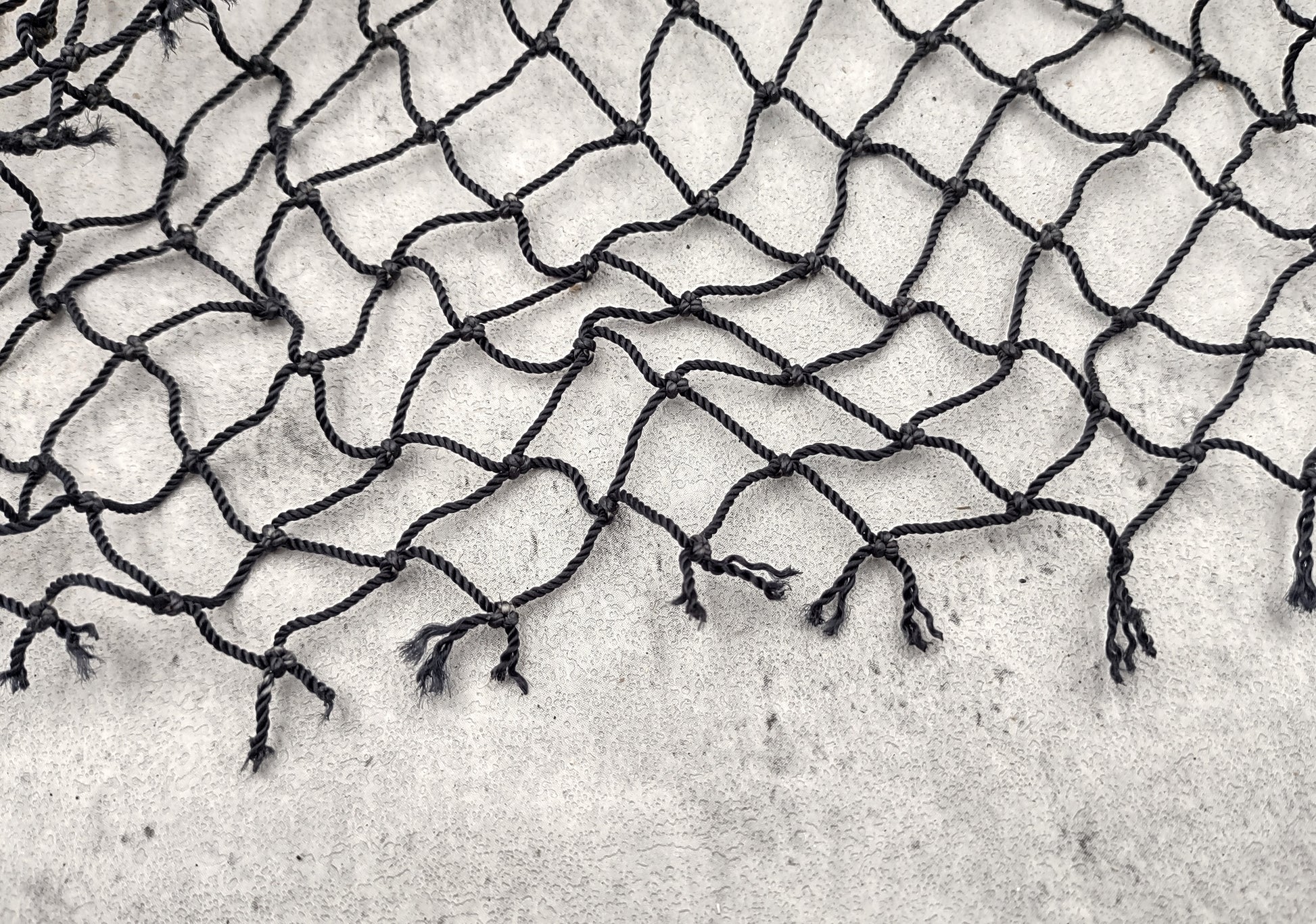 Fishing Net - Used (4 X 9 feet). One black tied fishing net that comes folded and banded. Copyright 2022 SeaShellSupply.com.