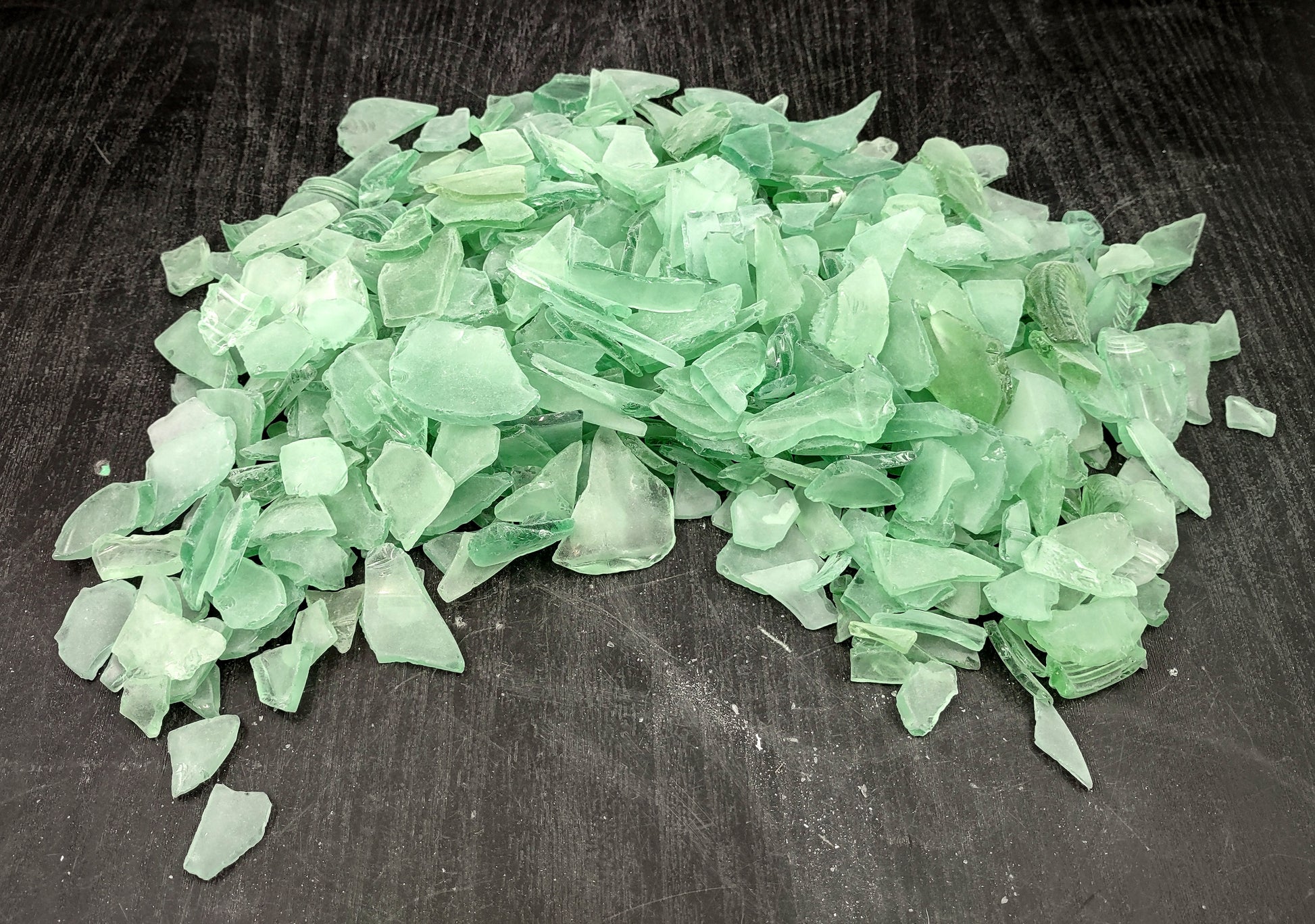 Beach Glass - Medium Tumbled Rough Coke Bottle Green - (approx. 1 Kilogram/2.2 lbs. .5-1.25 inches). Multiple green glass pieces in different shapes. Copyright 2024 SeaShellSupply.com.