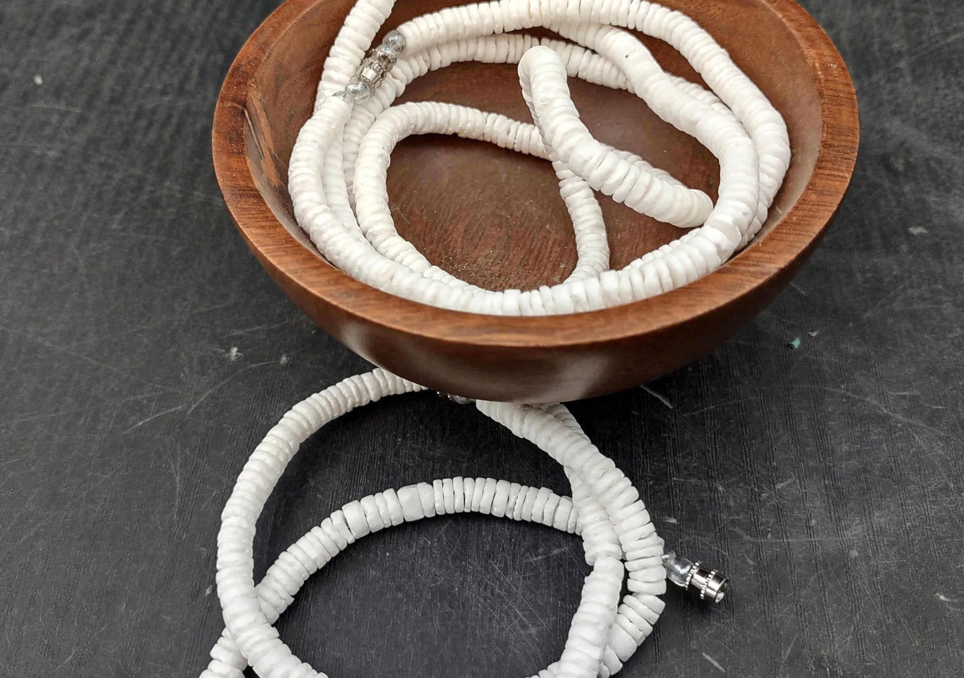 White Puka-Style Shell Necklace - (1 necklace 18 inches x 4-5mm) on blue background.  Copyright 2022 SeaShellSupply.com.