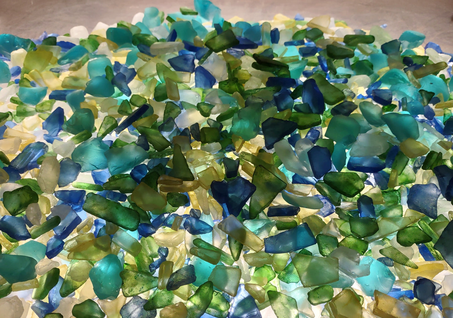 Beach Glass - Medium Tumbled Rough Blue, Green & White Atlantic Assorted - (approx. 1 Kilogram/2.2 lbs. .5-1.25 inches). Multiple different shapes and sizes pieces all in a pile. Copyright 2024 SeaShellMart.com.