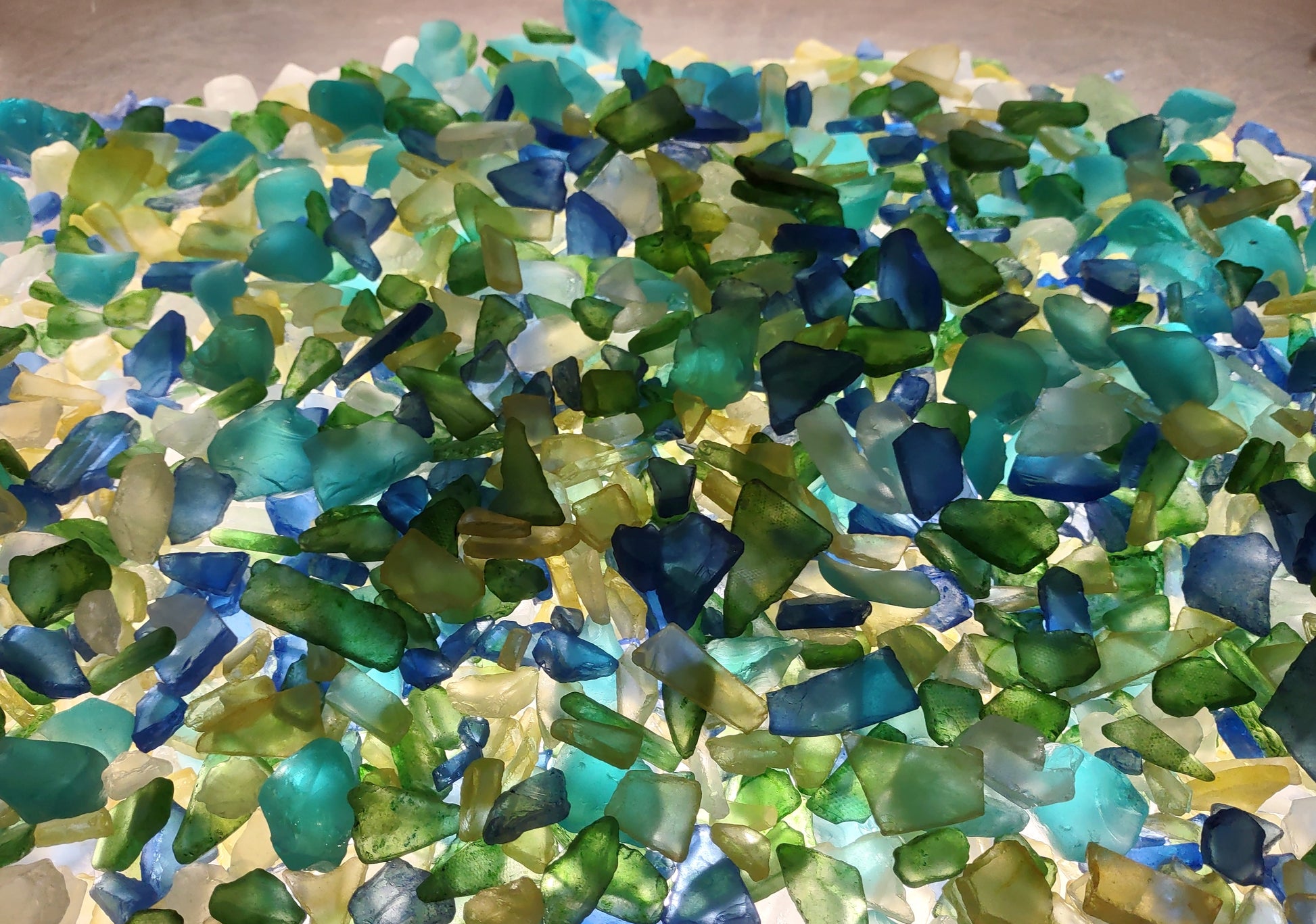 Beach Glass - Medium Tumbled Rough Blue, Green & White Atlantic Assorted - (approx. 1 Kilogram/2.2 lbs. .5-1.25 inches). Multiple different shapes and sizes pieces all in a pile. Copyright 2024 SeaShellMart.com.