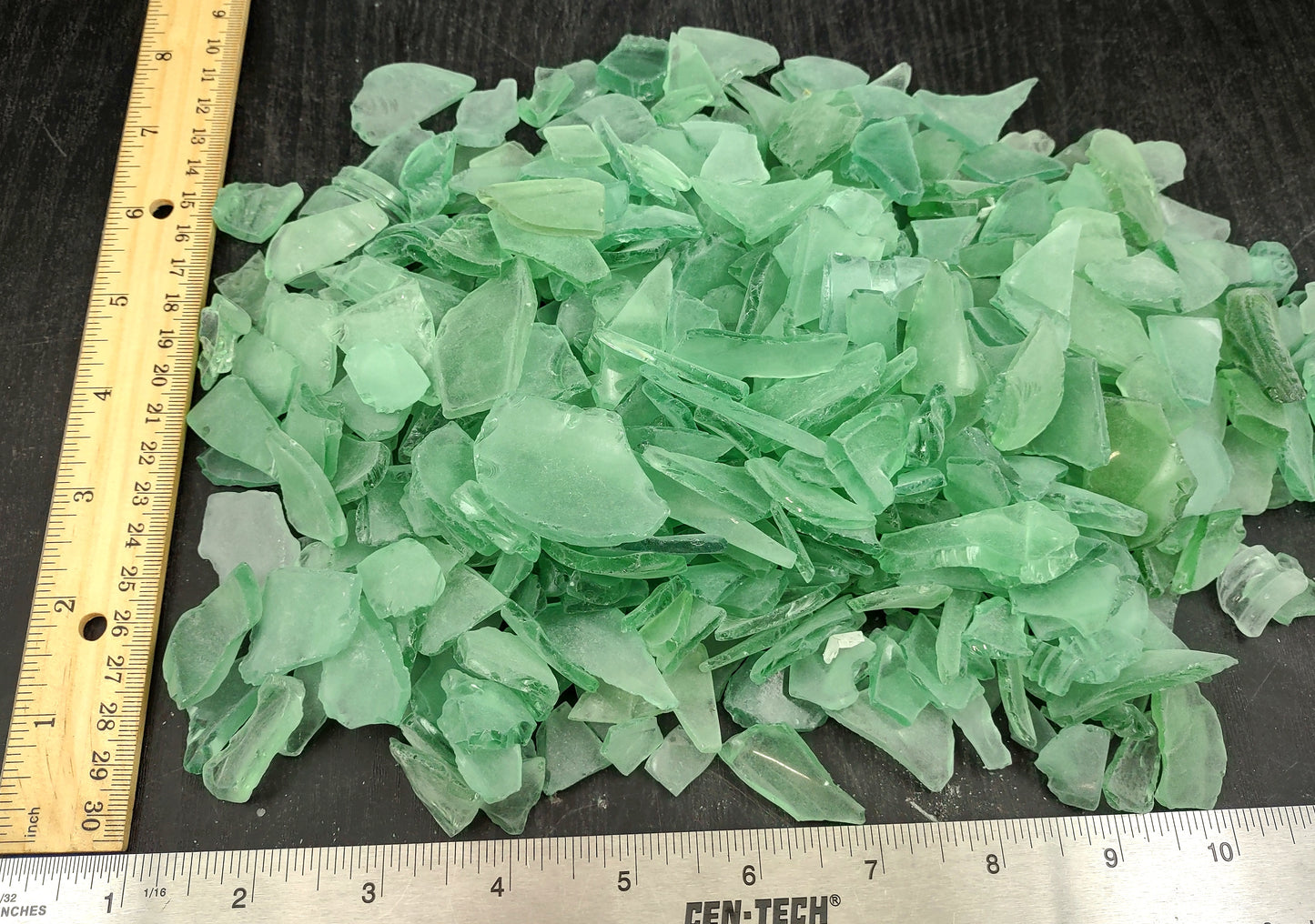 Beach Glass - Medium Tumbled Rough Coke Bottle Green - (approx. 1 Kilogram/2.2 lbs. .5-1.25 inches). Multiple green glass pieces in different shapes. Copyright 2024 SeaShellSupply.com.