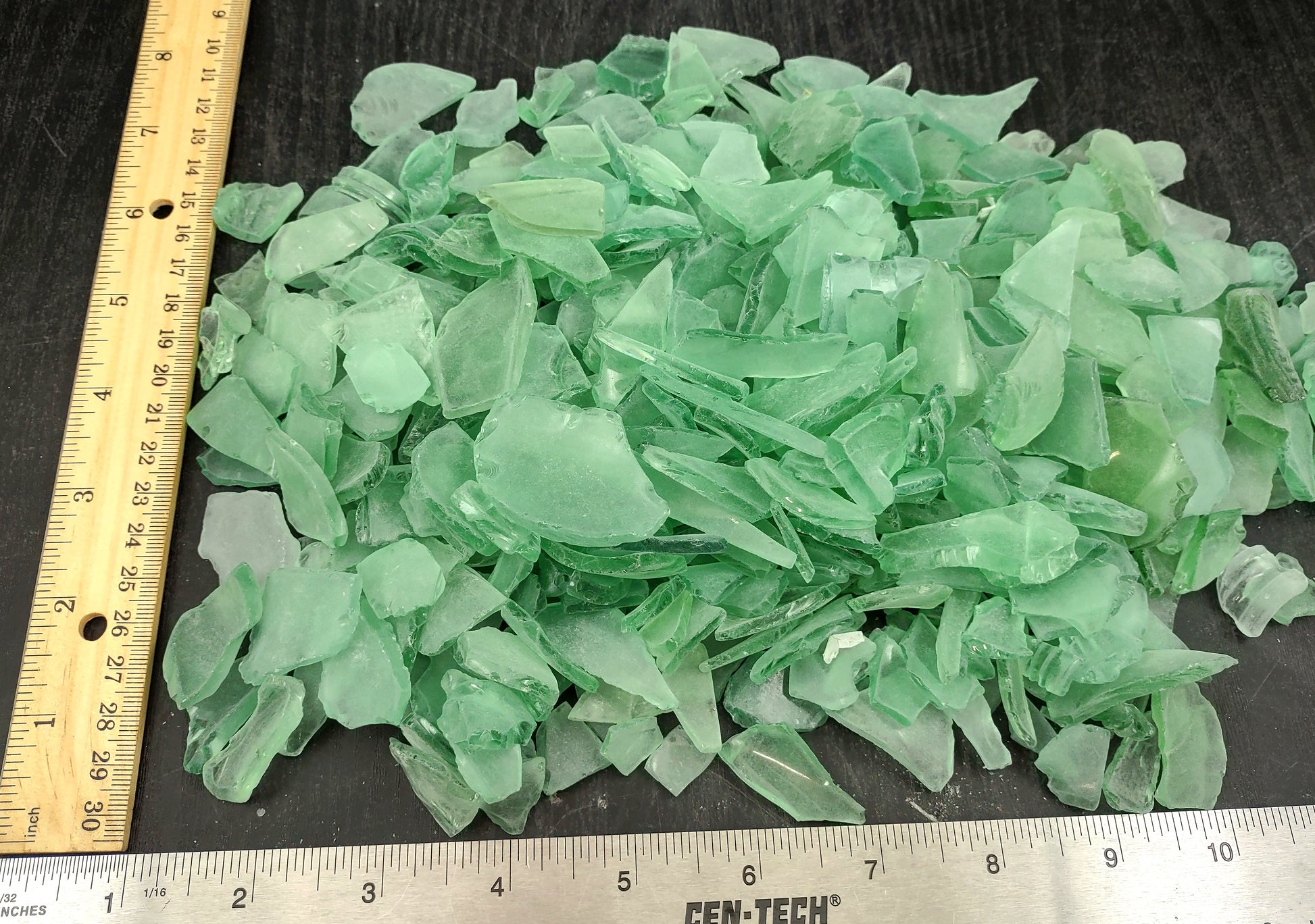 Beach Glass - Medium Tumbled Rough Coke Bottle Green - (approx. 1 Kilogram/2.2 lbs. .5-1.25 inches). Multiple green glass pieces in different shapes. Copyright 2024 SeaShellSupply.com.