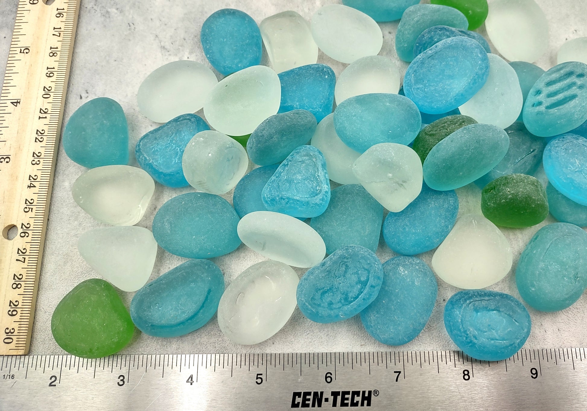 Beach Glass - Rounded Blue, Green & White Assorted Pebbles - (approx. 1 Kilogram/2.2 lbs. 1-1.5 inches). Multiple colored pebbles in a pile. Copyright 2024 SeaShellSupply.com.
