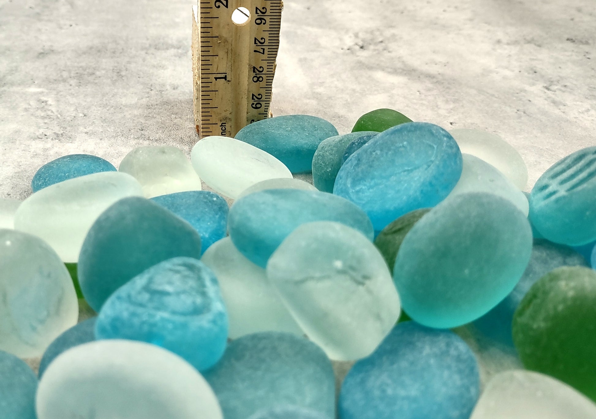 Beach Glass - Rounded Blue, Green & White Assorted Pebbles - (approx. 1 Kilogram/2.2 lbs. 1-1.5 inches). Multiple colored pebbles in a pile. Copyright 2024 SeaShellSupply.com.