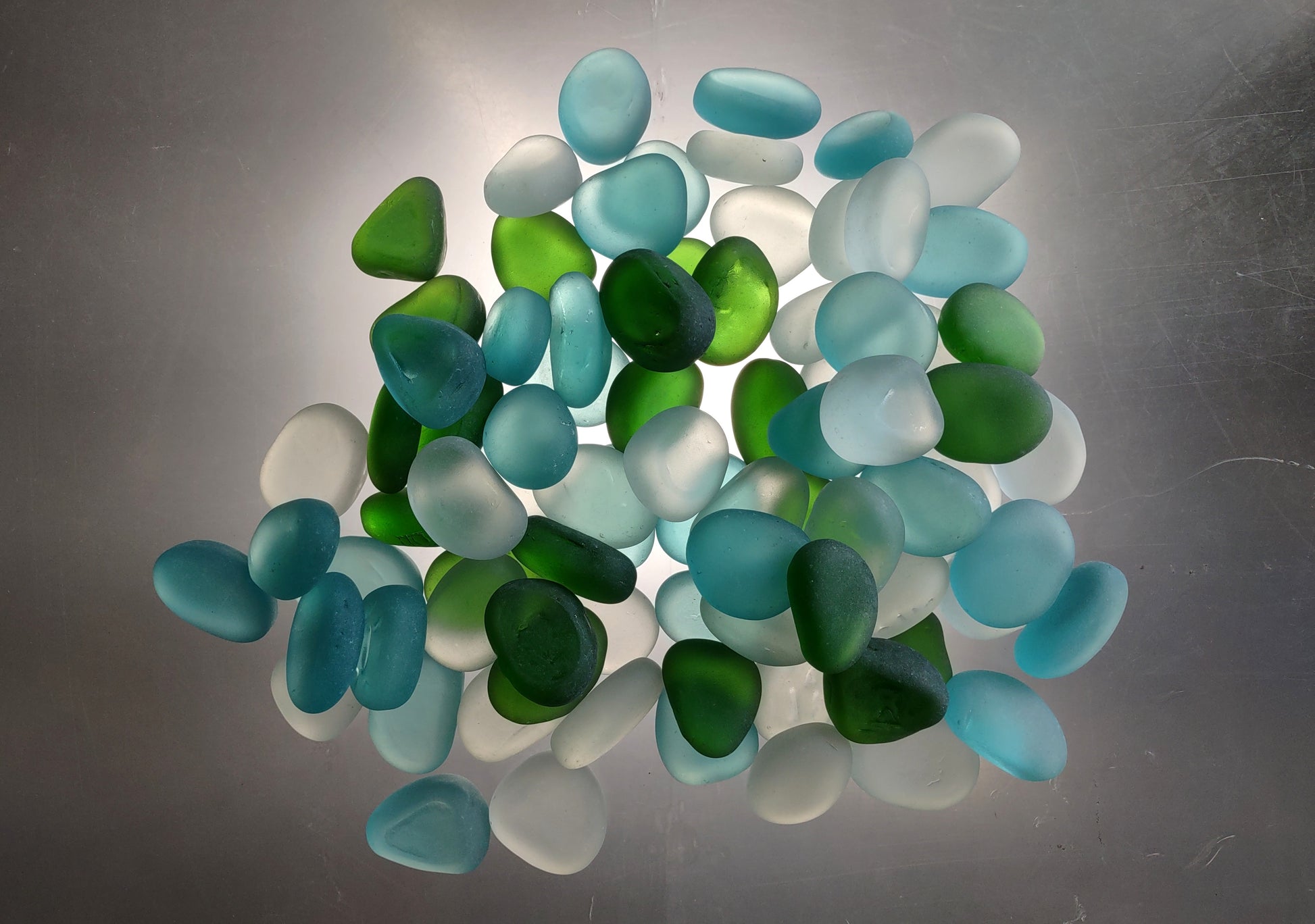 Beach Glass - Rounded Blue, Green & White Assorted Pebbles - (approx. 1 Kilogram/2.2 lbs. 1-1.5 inches). Multiple colored pebbles in a pile. Copyright 2024 SeaShellSupply.com.