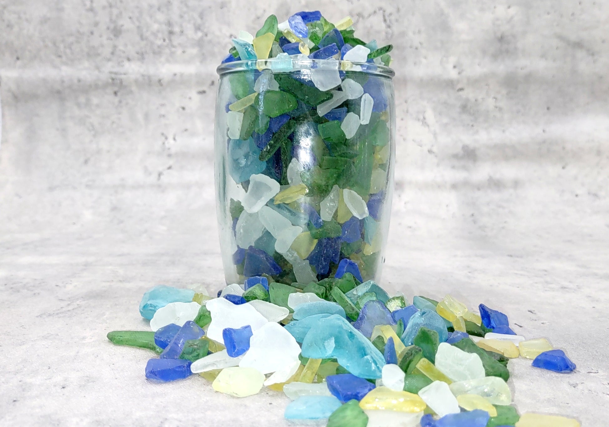 Beach Glass - Medium Tumbled Rough Blue, Green & White Atlantic Assorted - (approx. 1 Kilogram/2.2 lbs. .5-1.25 inches). Multiple different shapes and sizes pieces all in a pile. Copyright 2024 SeaShellMart.com.