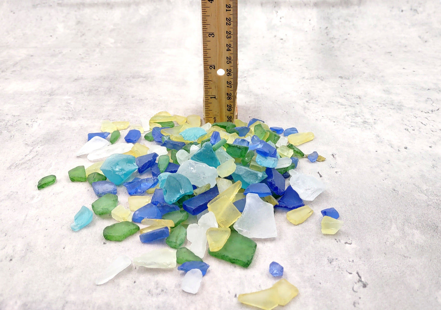 Beach Glass - Medium Tumbled Rough Blue, Green & White Atlantic Assorted - (approx. 1 Kilogram/2.2 lbs. .5-1.25 inches). Multiple different shapes and sizes pieces all in a pile. Copyright 2024 SeaShellMart.com.