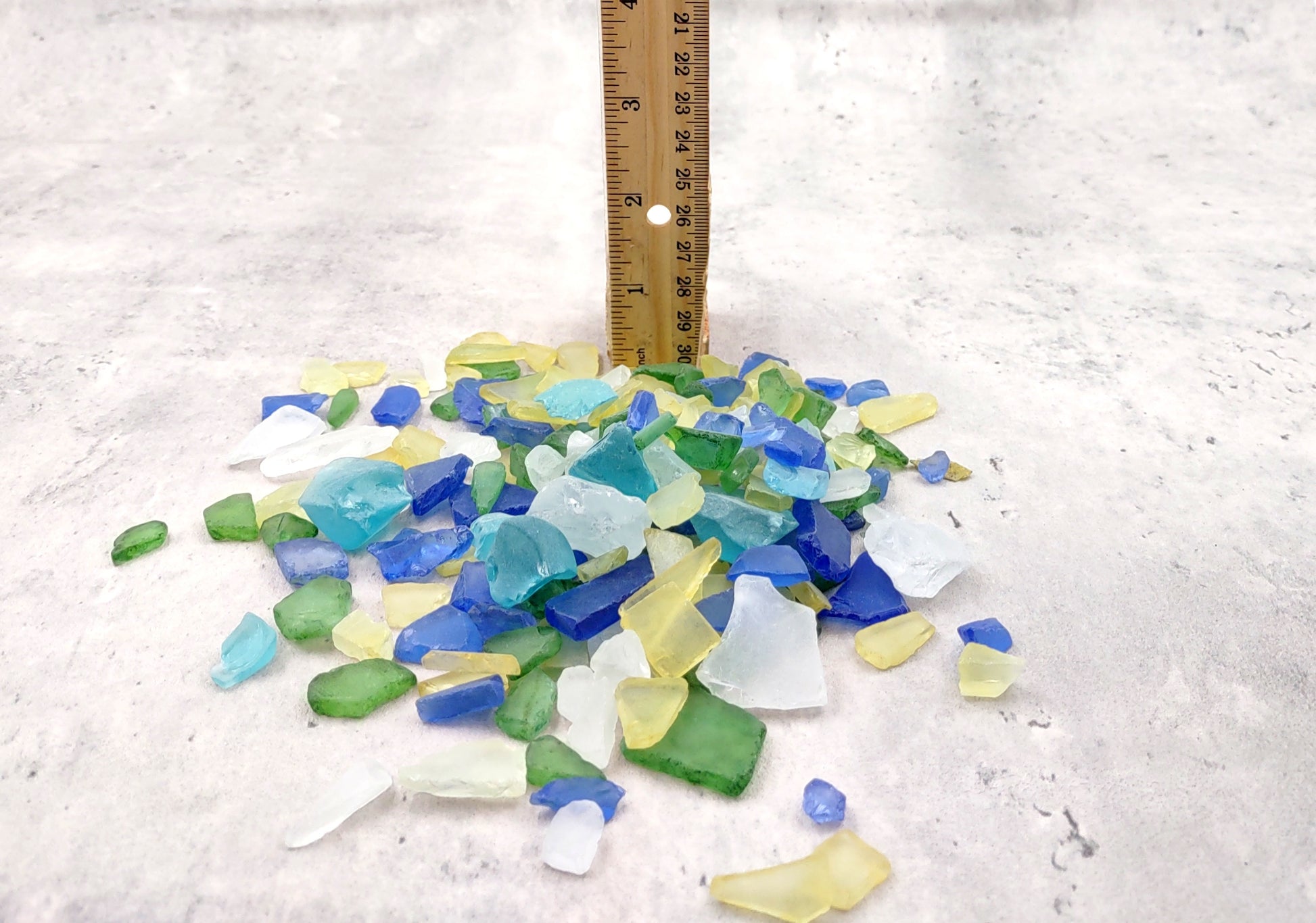 Beach Glass - Medium Tumbled Rough Blue, Green & White Atlantic Assorted - (approx. 1 Kilogram/2.2 lbs. .5-1.25 inches). Multiple different shapes and sizes pieces all in a pile. Copyright 2024 SeaShellMart.com.