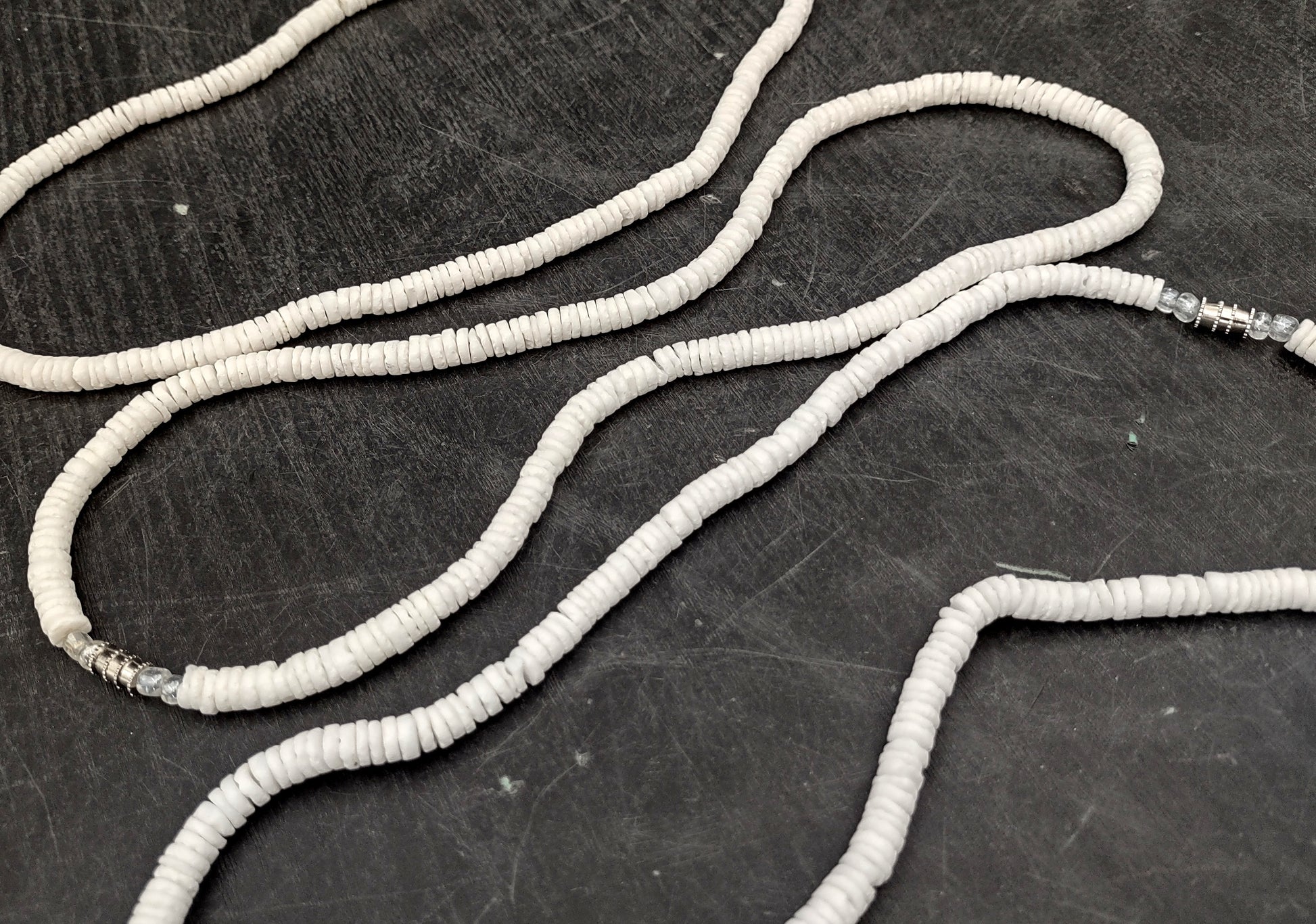 White Puka-Style Shell Necklace - (1 necklace 18 inches x 4-5mm) on blue background.  Copyright 2022 SeaShellSupply.com.