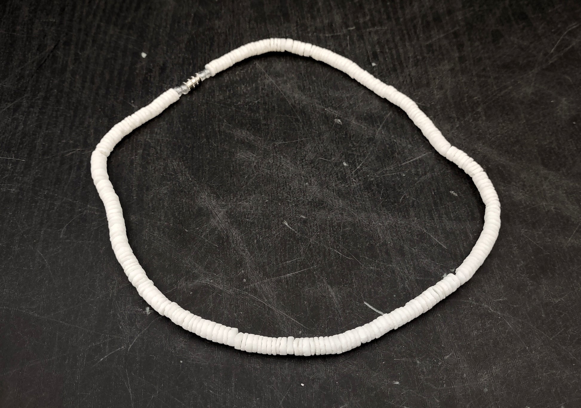 White Puka-Style Shell Necklace - (1 necklace 18 inches x 4-5mm) on blue background.  Copyright 2022 SeaShellSupply.com.