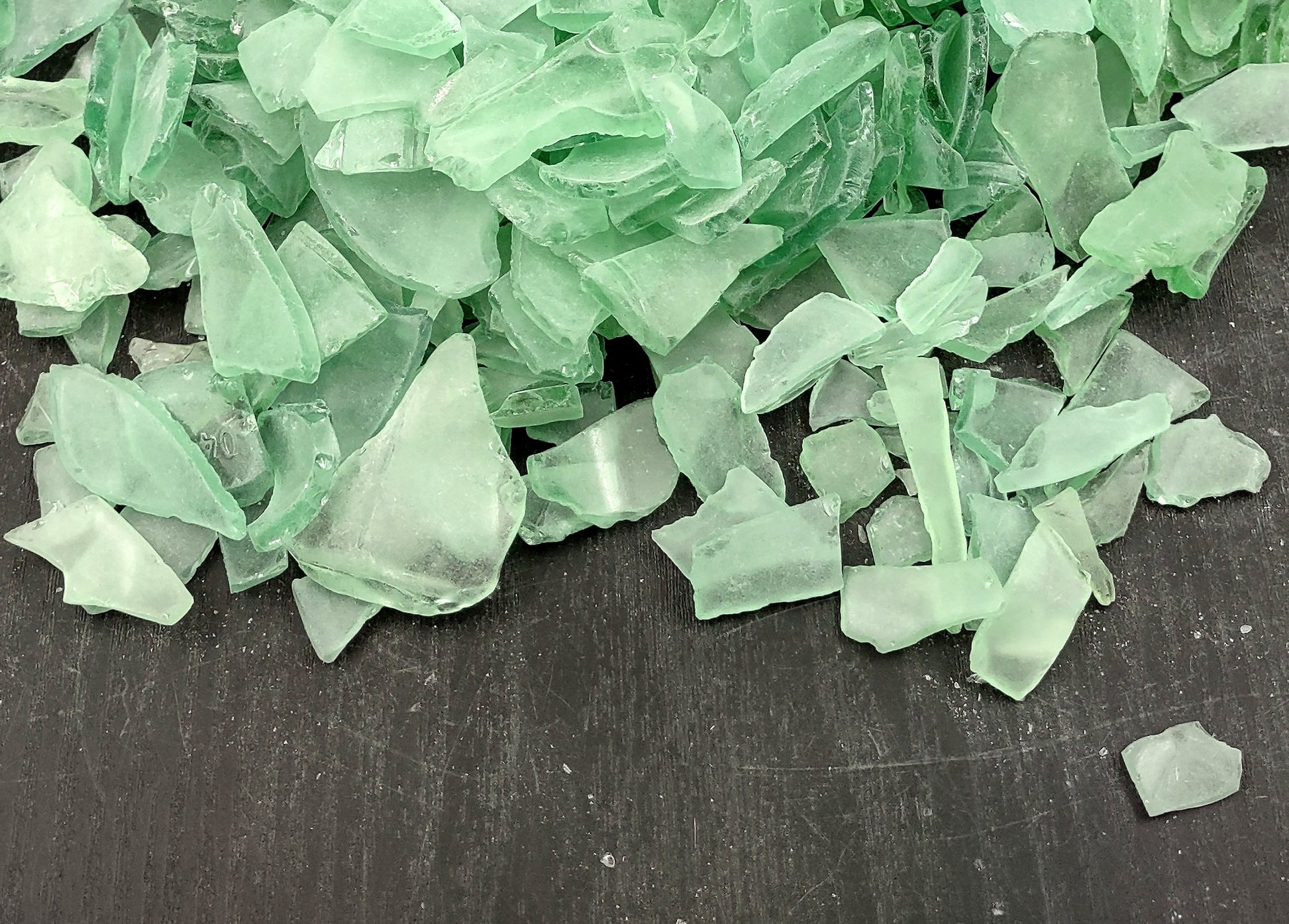 Beach Glass - Medium Tumbled Rough Coke Bottle Green - (approx. 1 Kilogram/2.2 lbs. .5-1.25 inches). Multiple green glass pieces in different shapes. Copyright 2024 SeaShellSupply.com.
