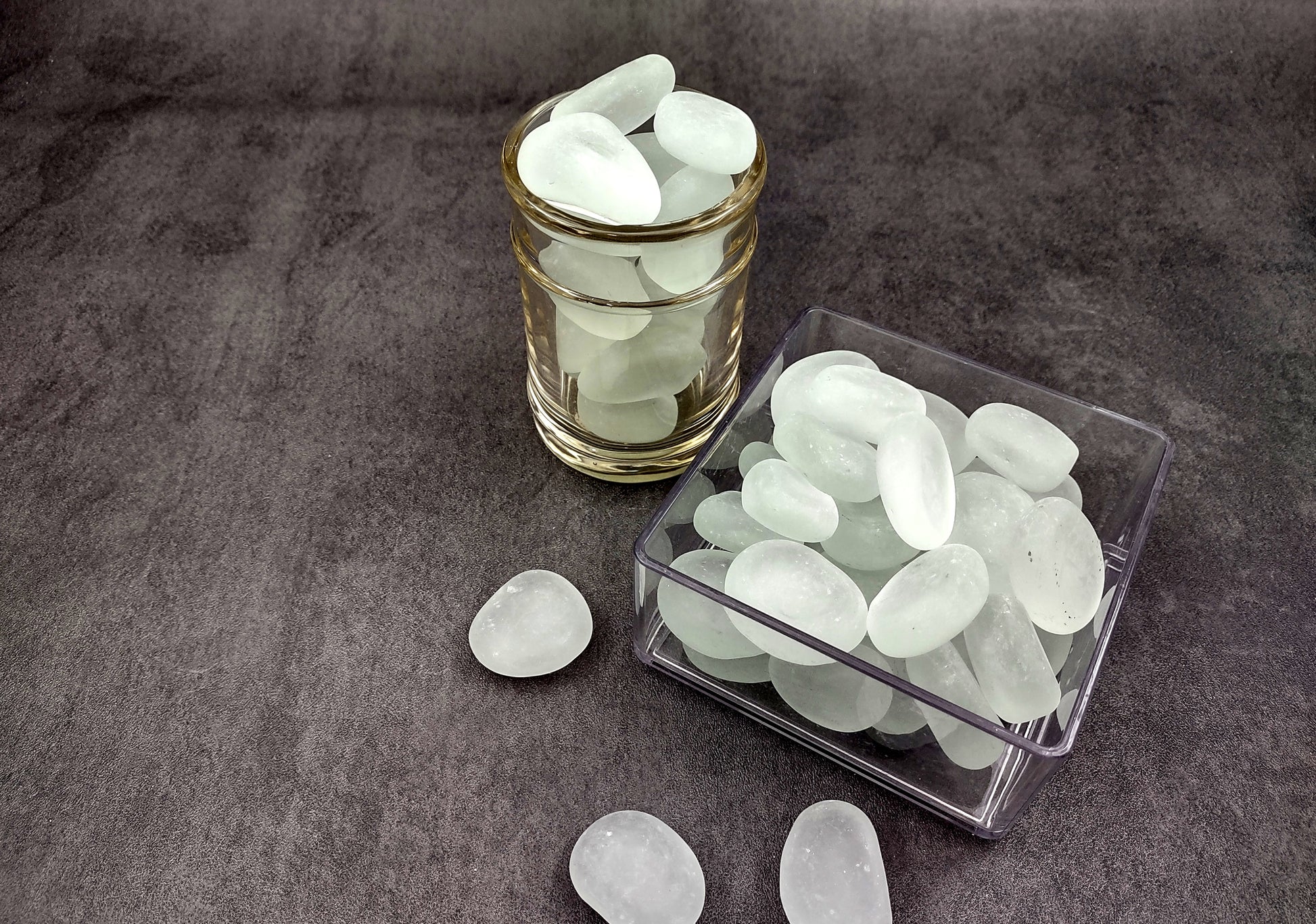 Beach Glass - Rounded Clear-White Frosted Pebbles - (approx. 1 Kilogram/2.2 lbs. 1-1.5 inches). Multiple lightly colored shells in a pile. Copyright 2024 SeaShellSupply.com.
