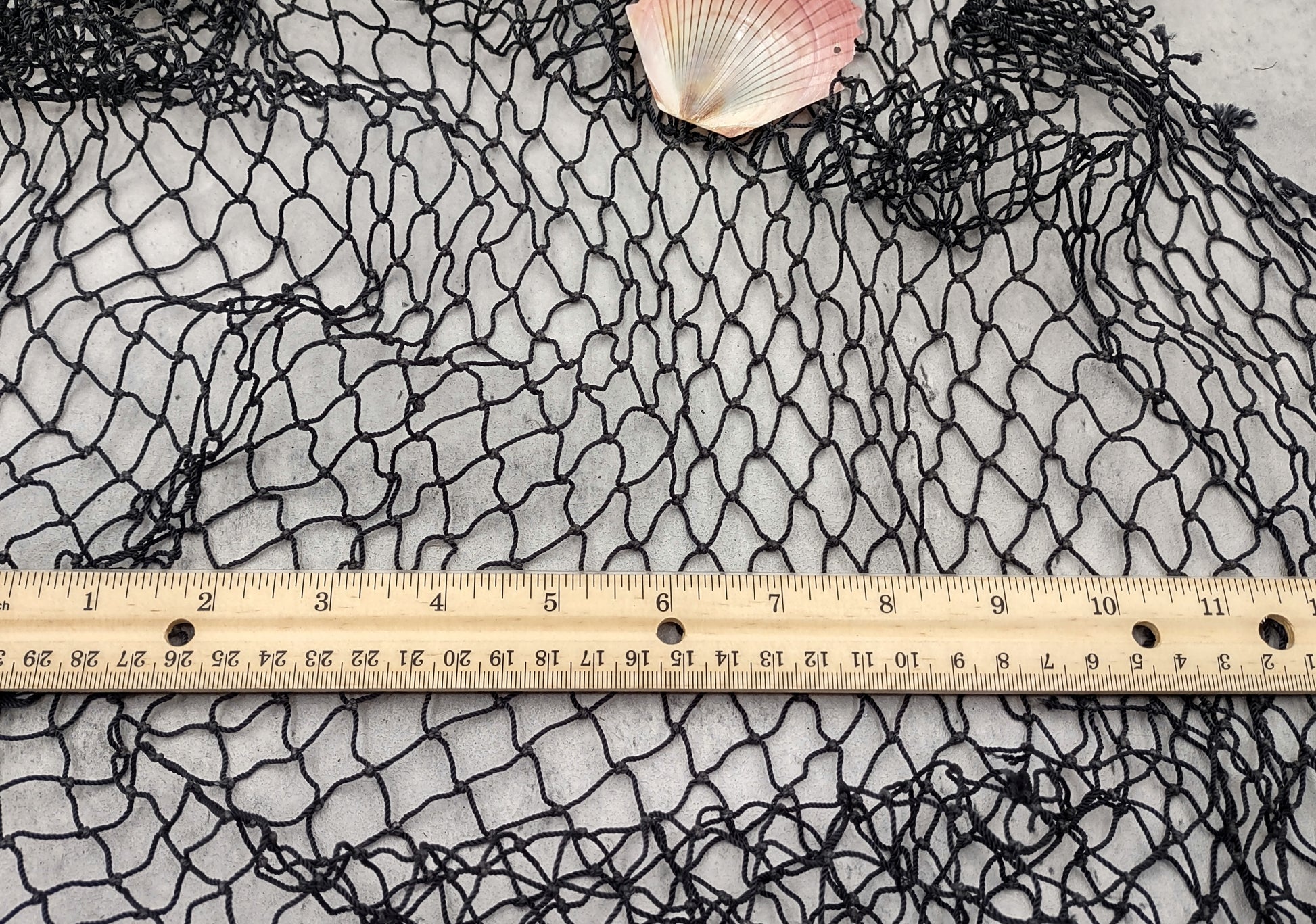Fishing Net - Used (4 X 9 feet). One black tied fishing net that comes folded and banded. Copyright 2022 SeaShellSupply.com.