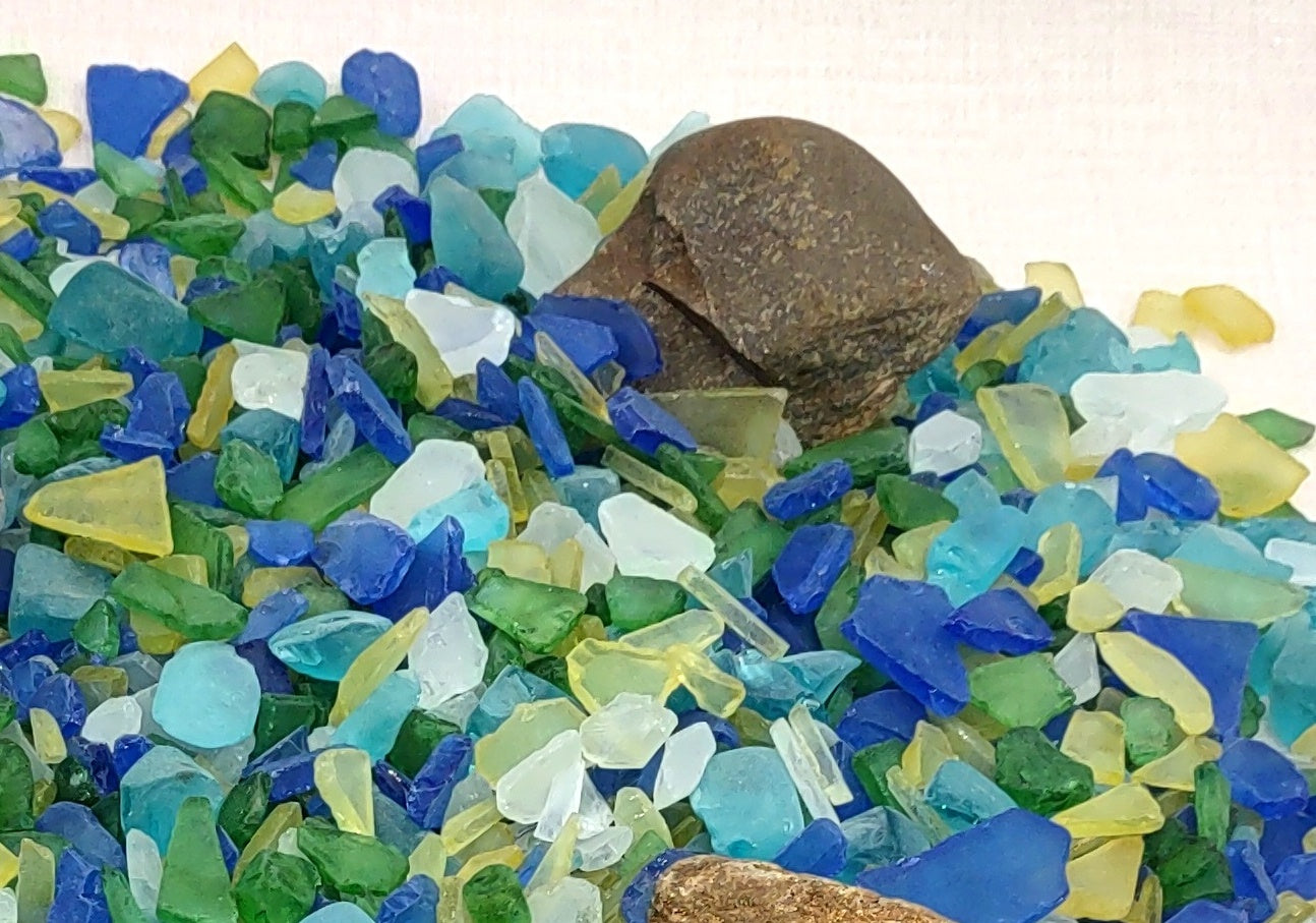 Beach Glass - Medium Tumbled Rough Blue, Green & White Atlantic Assorted - (approx. 1 Kilogram/2.2 lbs. .5-1.25 inches). Multiple different shapes and sizes pieces all in a pile. Copyright 2024 SeaShellMart.com.