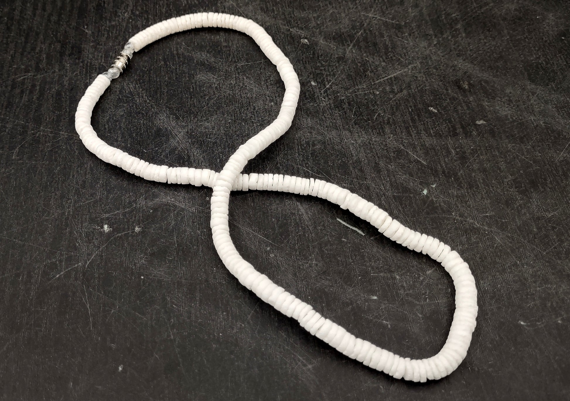 White Puka-Style Shell Necklace - (1 necklace 18 inches x 4-5mm) on blue background.  Copyright 2022 SeaShellSupply.com.