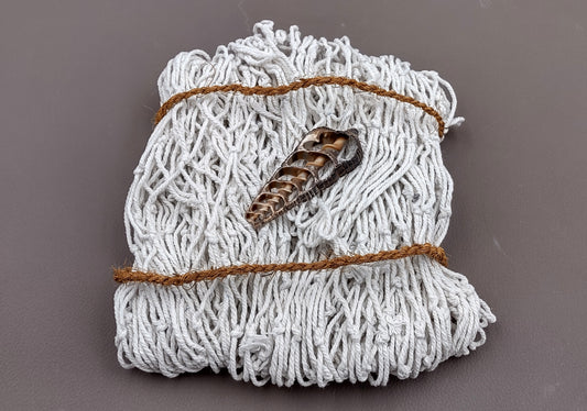 White Decorative Fish Net - (1 Net approx. 3.3 feet x 6.6 feet) on greyish background. Copyright 2022 SeaShellSupply.com.