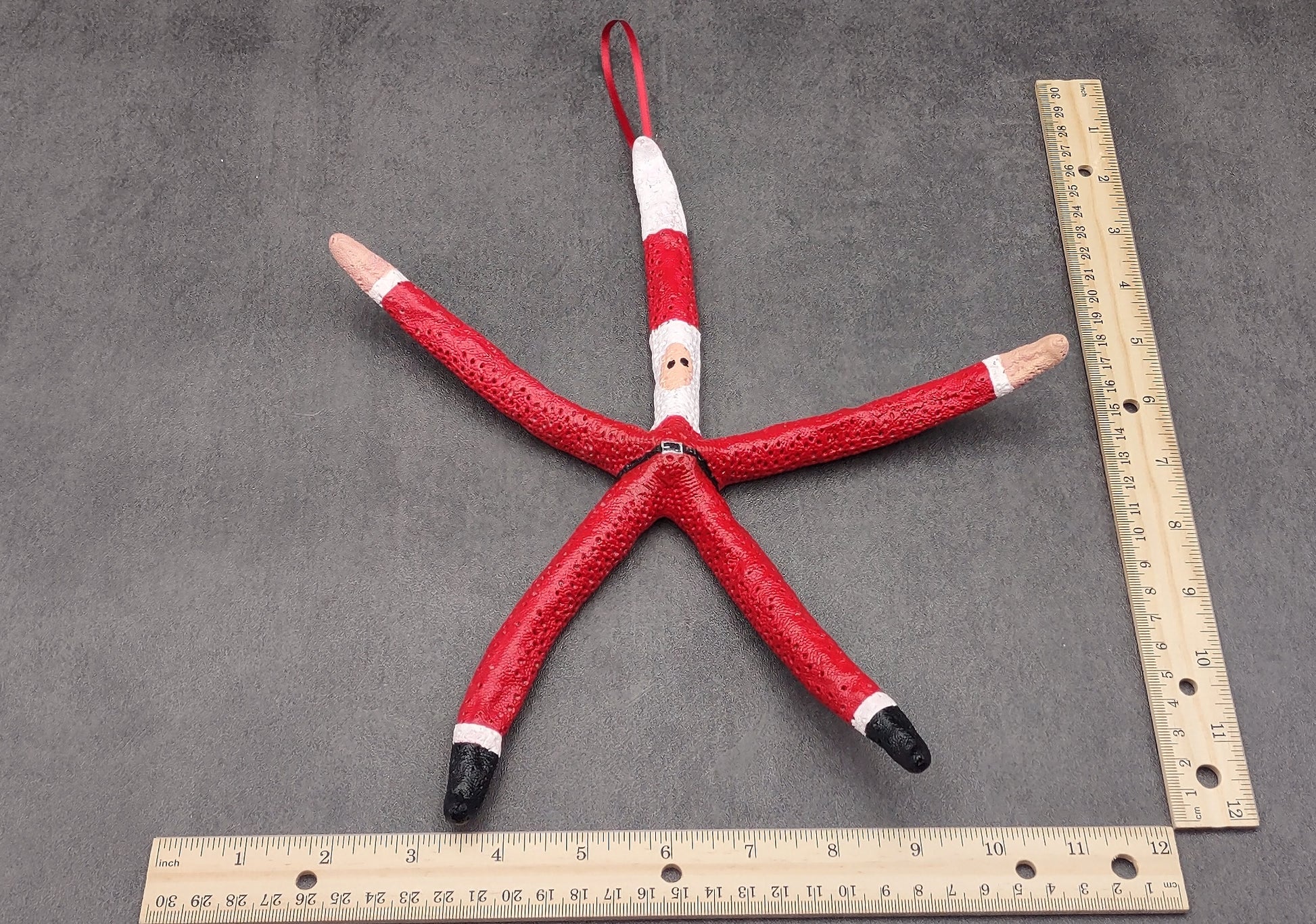 Red Linckia Starfish Santa Claus Ornament (1 seastar approx. 10-12 inches) Painted Santa Claus Starfish Ornament For Coastal Beach Christmas. Copyright 2023 SeaShellSupply.com.